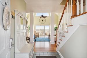 a hallway of a home with stairs and a living room at 1015 E Arctic Ave Dolphins Folly Oceanfront Home in Folly Beach