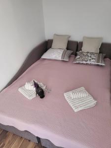 a large pink bed with two pillows on it at Tića in Laćarak