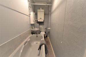 a bathroom with a bath tub and a sink at Victoria Bay - Whole Apt - 2 Bed - WiFi - Beach - Harbour - Herne Bay in Herne Bay