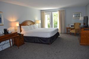 a hotel room with a bed and a desk and a desk at Dundee Resort & Golf Club in West Bay