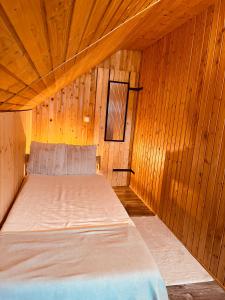 a room with a bed in a wooden cabin at Brenner‘s Waldhaus in Hergersweiler