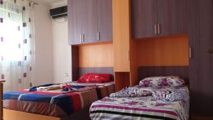 Zimmer mit 2 Betten und Schränken in der Unterkunft Holiday Apartment in Lezha