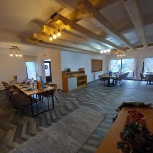 a large room with tables and chairs in it at Liniștea Codrului in Borşa