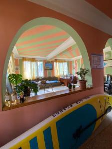 a room with a surfboard in front of a living room at Princ Georgia in Ureki