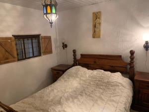 Ένα ή περισσότερα κρεβάτια σε δωμάτιο στο Le petit cottage