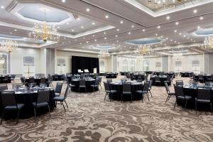 a banquet hall with tables and chairs and chandeliers at Sheraton Charlotte Hotel in Charlotte