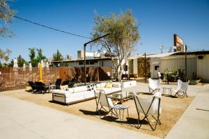 a patio with couches and chairs and a table at Cuyama Buckhorn in New Cuyama