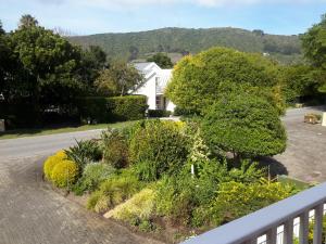 a white house with a garden on a balcony at Island Nest in Knysna