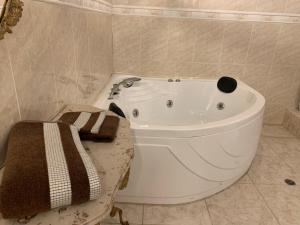 a bathroom with a large white tub in a room at Casa Skema - Garden in Quito