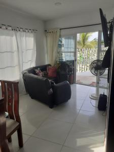 sala de estar con sofá y mesa en Casa - Cabaña ELA en Coveñas, frente al mar, en Coveñas