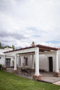 a white house with a patio with a roof at Tampu in Cachí