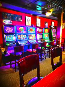 a room with many slot machines in a casino at Royal Duke Hotel in Okotoks