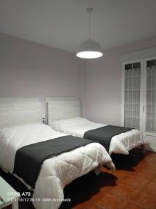 Posteľ alebo postele v izbe v ubytovaní CASA PUERTA DEL BOROSA