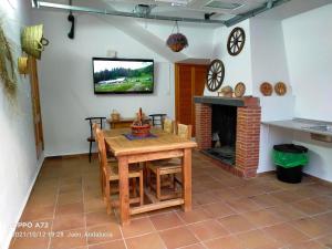a dining room with a table and a fireplace at CASA PUERTA DEL BOROSA in Coto Ríos