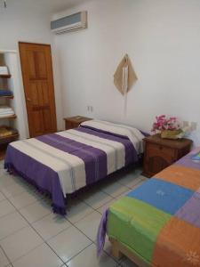 A bed or beds in a room at Lush Garden House near beaches with private pool.