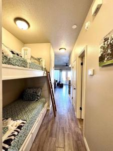 a hallway with bunk beds in a room at Guadalupe Getaway in New Braunfels