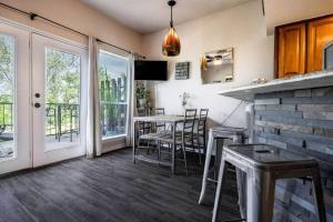 a kitchen with a table and chairs and a balcony at Guadalupe Getaway in New Braunfels