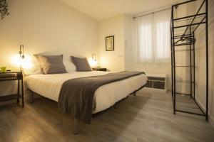 a bedroom with a large bed and a window at Alojamientos Cantíber in Santander