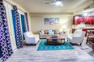 a living room with a couch and chairs and a table at Laketown Wharf Resort 1036 By Aneliya in Panama City Beach