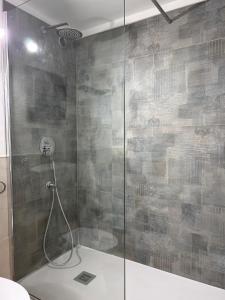 a shower with a glass door in a bathroom at Noralù House in Grottaferrata +16 photos