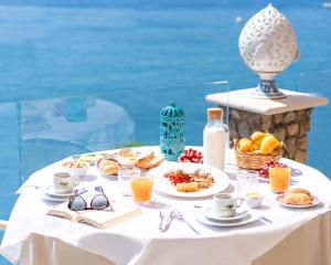 a white table with breakfast foods and drinks on it at Hotel Ferdinando Beach & Thermal Spa in Ischia