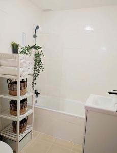 a bathroom with a white rack with plants on it at Niza Mar in Vélez-Málaga