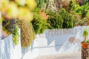 a white fence with plants on top of it at Hotel Ferdinando Beach & Thermal Spa in Ischia