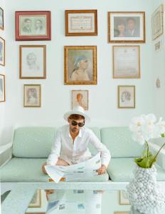 a man sitting on a couch reading a newspaper at Hotel Ferdinando Beach & Thermal Spa in Ischia