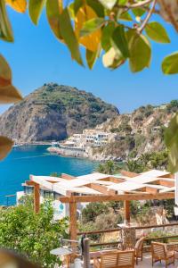 a view of a beach with chairs and umbrellas at Hotel Ferdinando Beach & Thermal Spa in Ischia
