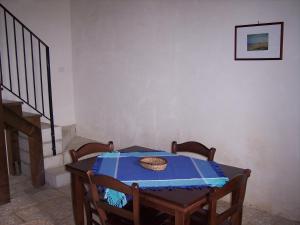 a table with a blue table cloth on it at Case di Cutalia - Villa Cutalia in Camemi