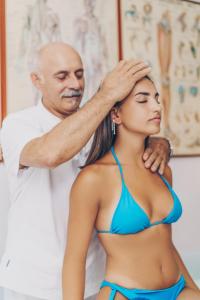 a man helping a woman with her hair at Hotel Ferdinando Beach & Thermal Spa in Ischia