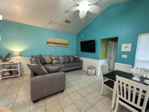 a living room with a couch and a table at Barefoot Bungalow - Pet Friendly- 2 Bdrm Townhome in Corpus Christi