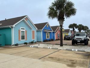 a truck parked in front of a row of houses at Barefoot Bungalow - Pet Friendly- 2 Bdrm Townhome in Corpus Christi