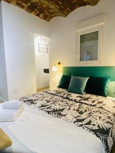 a bedroom with a large bed with a green headboard at ElenaHost City Park Center 5 in Madrid