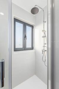 a bathroom with a shower and a window at Terrace Douro in Vila Nova de Gaia