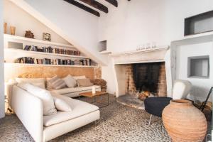 a living room with a couch and a fireplace at Refugio Son Pons in Campanet