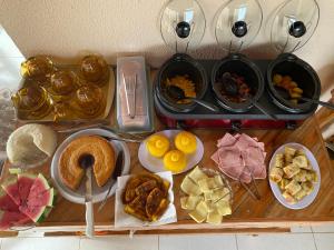a table topped with different types of food on a stove at RDS Hospedagem in Itacaré