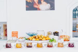 a table with a bunch of fruits and jams at Hotel Ferdinando Beach & Thermal Spa in Ischia