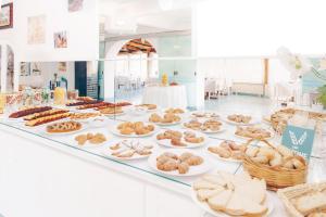 a table filled with lots of different types of pastries at Hotel Ferdinando Beach & Thermal Spa in Ischia