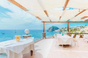 a dining room with a view of the ocean at Hotel Ferdinando Beach & Thermal Spa in Ischia