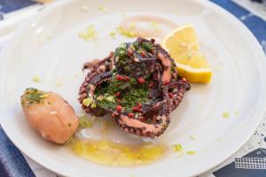 a plate of food with a shrimp and a lemon at Hotel Ferdinando Beach & Thermal Spa in Ischia