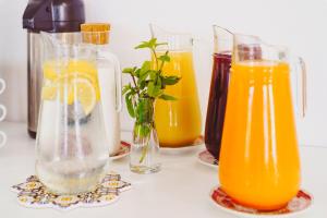 a group of glass vases filled with orange juice at Hotel Ferdinando Beach & Thermal Spa in Ischia