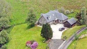 an aerial view of a large house with a car at The Byre in Strathyre