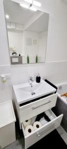 a bathroom with a sink and a mirror at New Modern SelfCheckin PublicFreeParking HighSpeed Wifi KingSizeBed in Baden-Baden