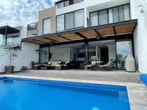 a house with a swimming pool in front of a house at Amazing house with private pool and beautiful view in San Miguel de Allende