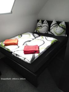a bed with three pillows on top of it at Anbau in Evestorf