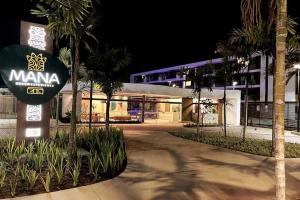 a sign in front of a building at night at Beautiful studio Muro Alto mana beach in Ipojuca