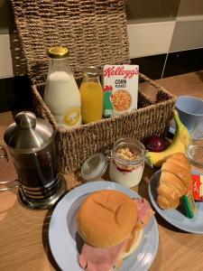 a table with a sandwich and a basket of milk at Bella Vista in Paignton