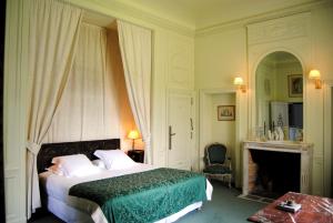 a bedroom with a bed and a fireplace at Château d'Urtubie in Urrugne