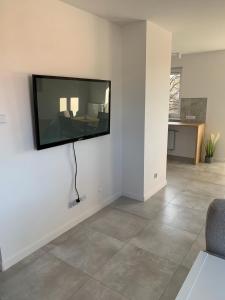 a living room with a flat screen tv on the wall at Apartament Cieplice in Jelenia Góra
